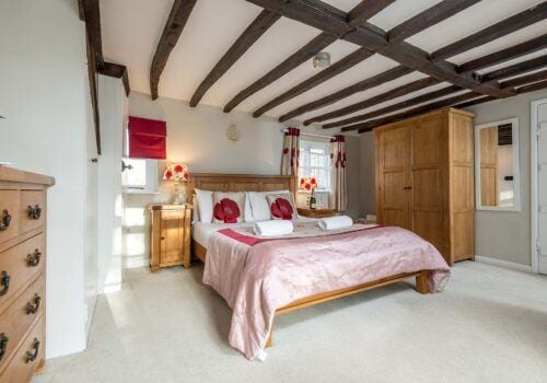 New Forest Cottage ensuite master bedroom Beck Cottage with red lamps and pillows