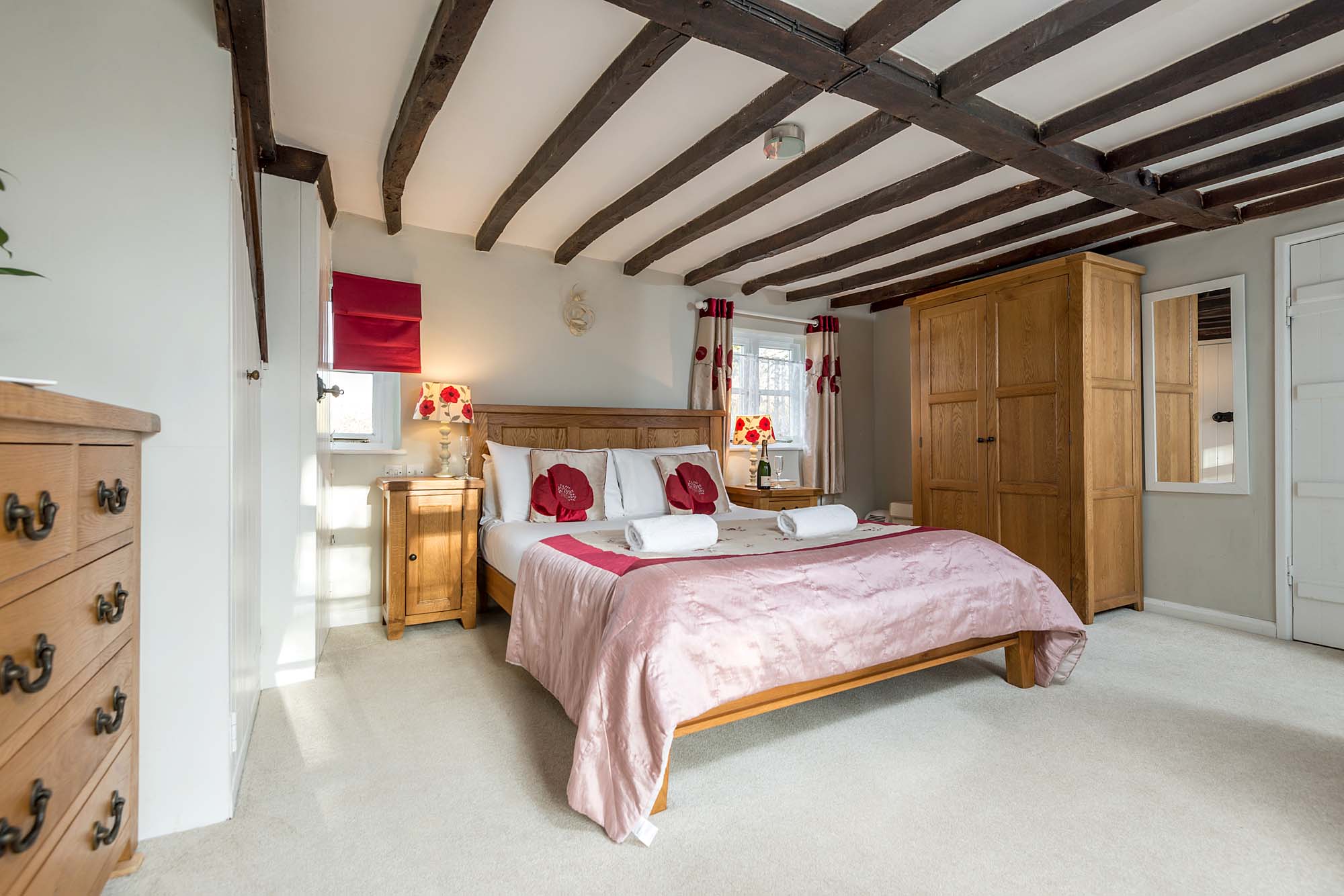 New Forest Cottage ensuite master bedroom Beck Cottage with red lamps and pillows