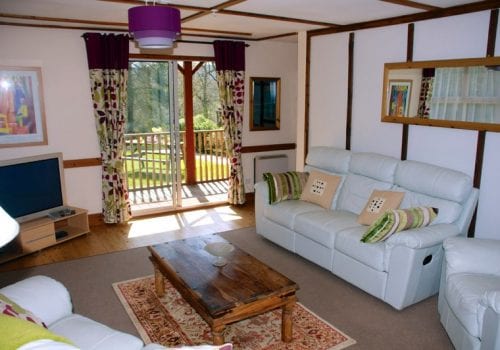 Carp Lodge lounge with sliding doors to verandah and garden