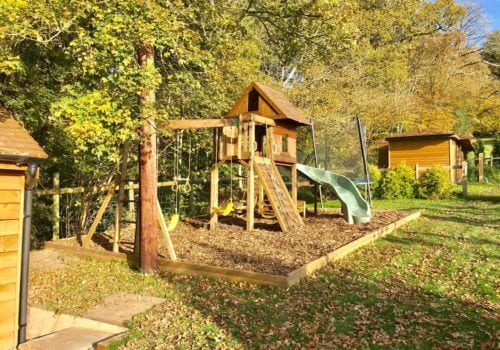 Mews Hill Children's play area with woodchip ground around the climbing frame
