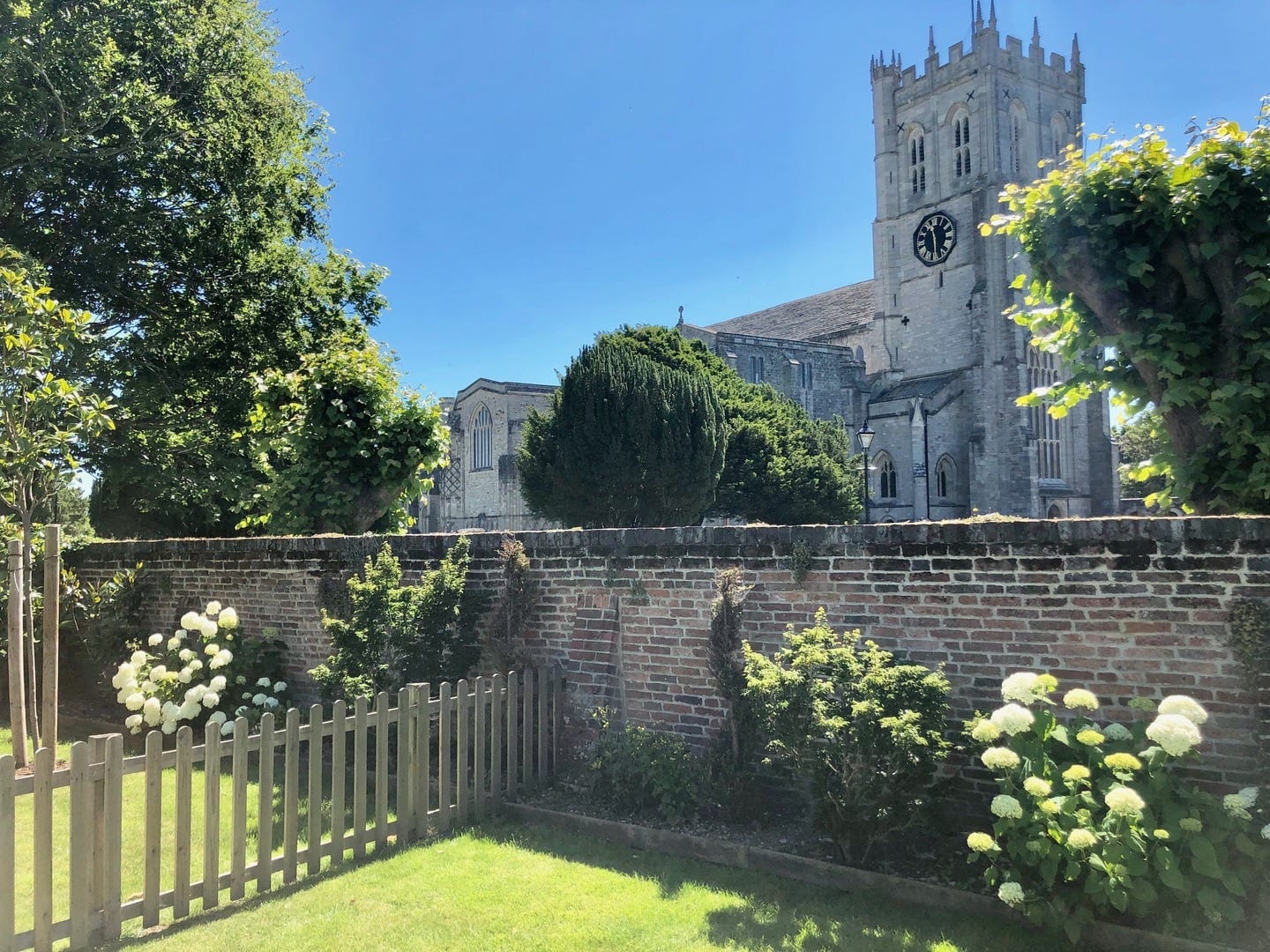 Quay House fantastic garden view of Christchurch Priory surrounded by beautiful flowers and trees