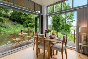 Bi-fold doors to verandah bring the outside in at Riverside Lodge self catering cottage in the New Forest