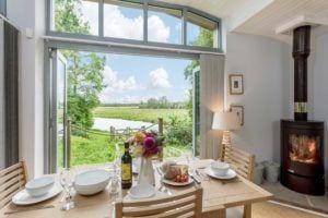 Dining table with flowers and a stunning view across the River Avon