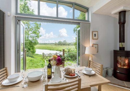 Dining table with flowers and a stunning view across the River Avon