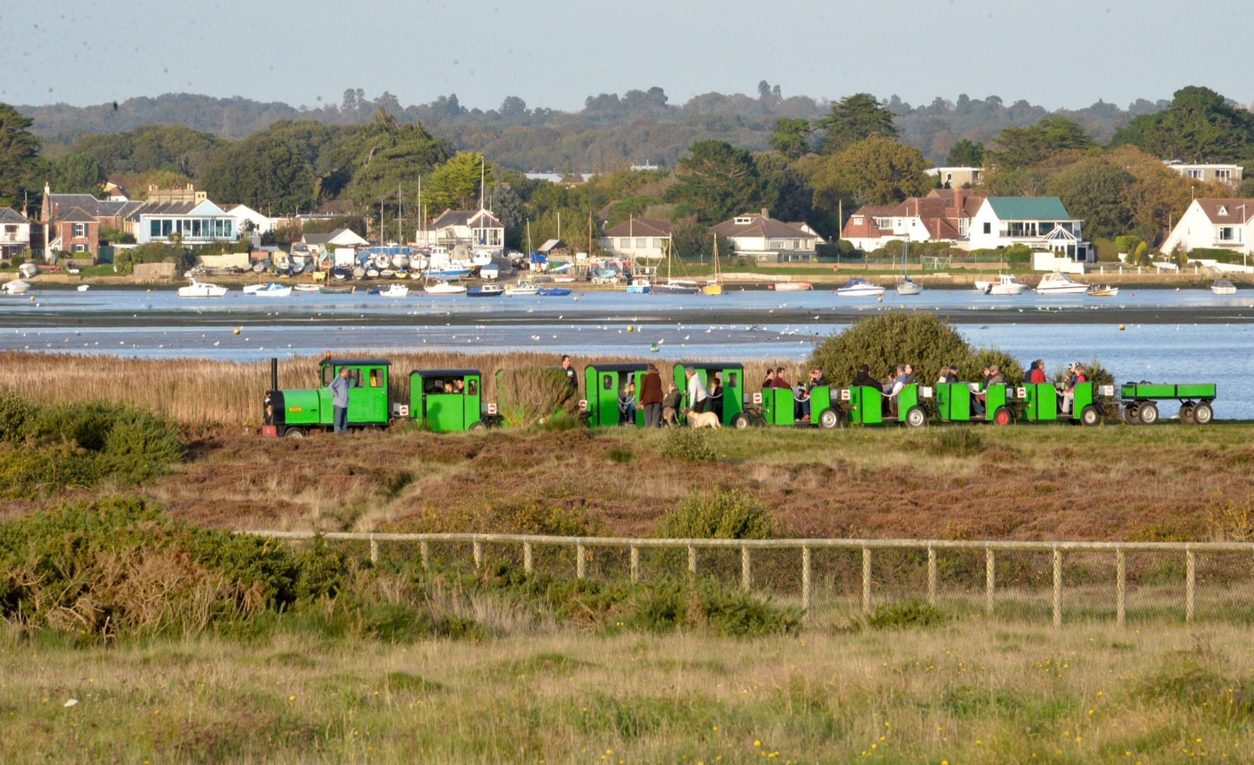 Hengistbury Head train with sailing boats and houses in the background