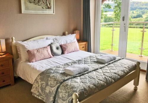 Master bedroom with balcony and ensuite in holiday let in Devon