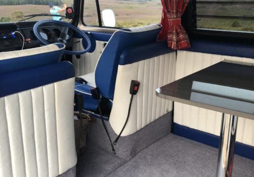 Front seats and table in rear of the campervan
