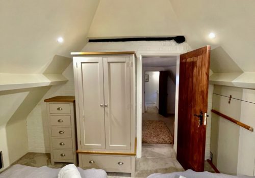 Twin bedroom under vaulted ceiling