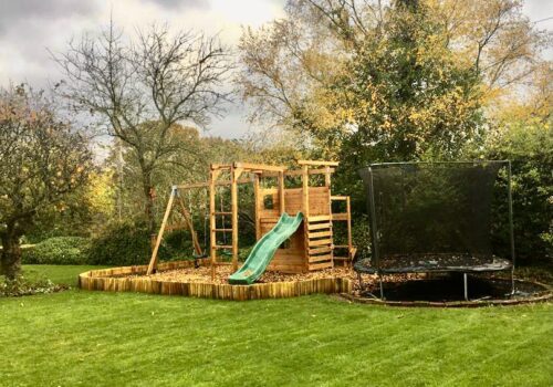 Childrens play frame and trampoline in a rural setting