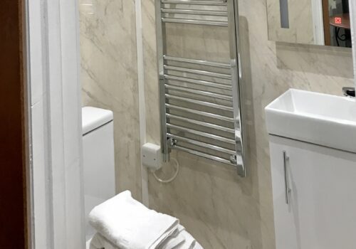 Interior shot of ensuite shower with towels