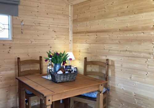 Shepherds hut interior with table and chairs