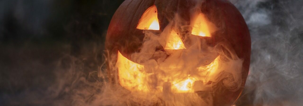 Halloween Pumpkin with a smile. Smoke surrounding and lit up.