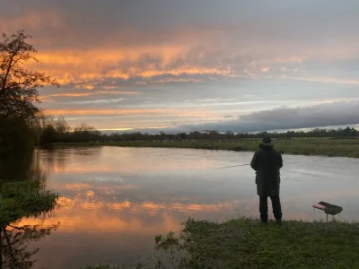 Beautiful-evening-fishing-1-1024x768 A solitary angler stands with his fishing rod in the sunset on a river
