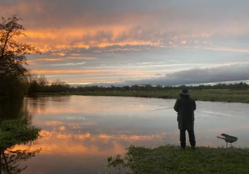 Beautiful-evening-fishing-1-1024x768 A solitary angler stands with his fishing rod in the sunset on a river