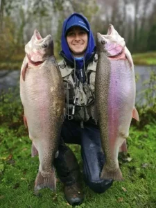 admin-ajax Angler holiding up 2 very large fish with a large grin on his face